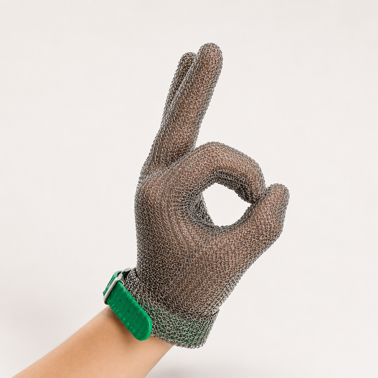 Hand wearing a stainless steel mesh safety glove